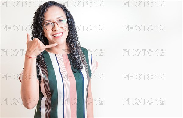 Happy girl in glasses gesturing call me with hand isolated. Latin woman in glasses gesturing call with fingers isolated