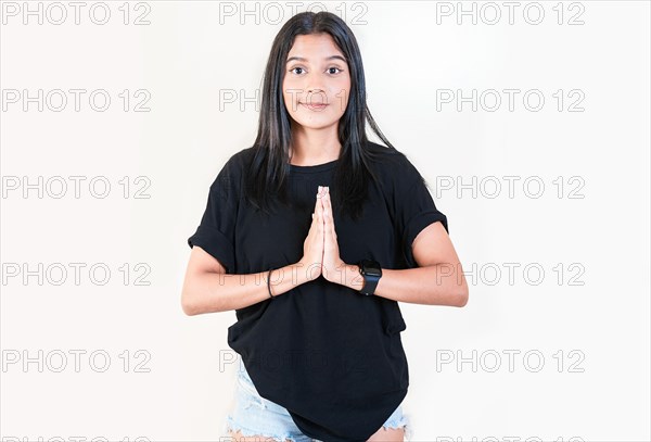 Beautiful young girl asking for a favor isolated. Latin girl asking for help with her hands isolated