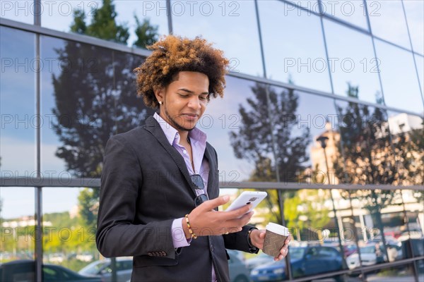 Portrait with copy space of an african american businessman using mobile on a coffee break