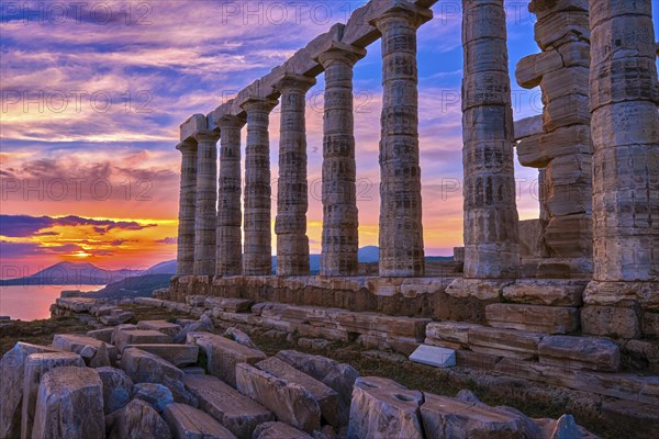 Beautiful sunset sky and ancient ruins of temple of Poseidon