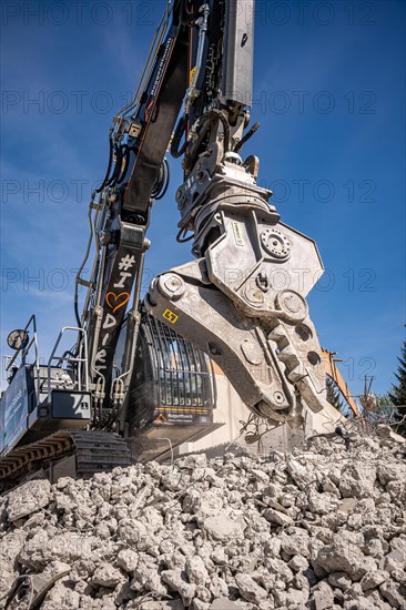 Black Liebherr crawler excavator recycling on demolition site