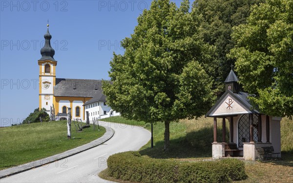 Wooden sculptures at the Stations of the Cross on Kirchberg with parish church