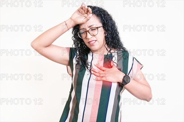 Young woman with tachycardia. Latin girl with heart pain on isolated background. Concept of people with heart problems