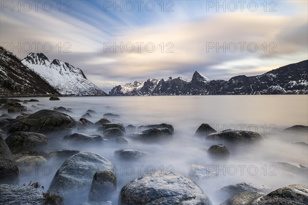 Snowy mountains by the fjord