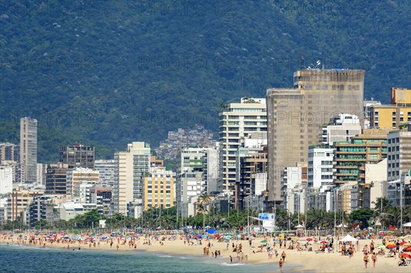 Summer day in the city of Rio de Janeiro with Ipanema beach occupied by city residents and tourists