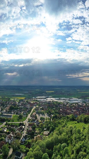 Aerial view of Koenigsberg in Bavaria. The city is surrounded by hills and forests. The sky is cloudy and dark