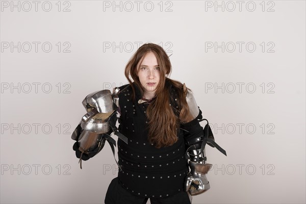 History of the Middle Ages. Portrait of a beautiful medieval female knight in armour on a white background