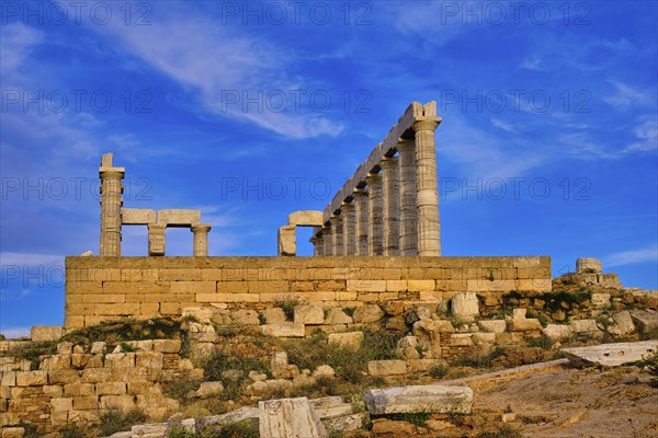 Beautiful sunset sky and ancient ruins of temple of Poseidon