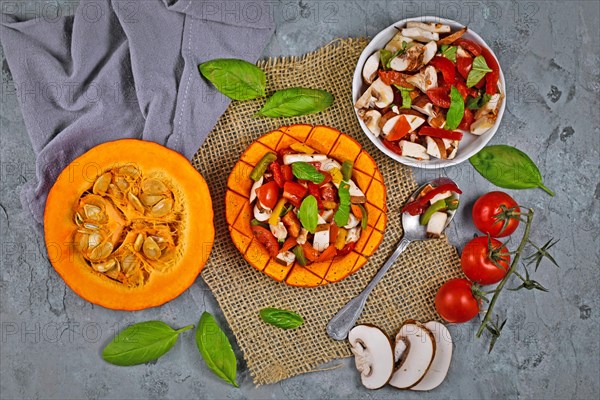 Top view of baked vegan Red kuri squash vegetable filled with bell pepper