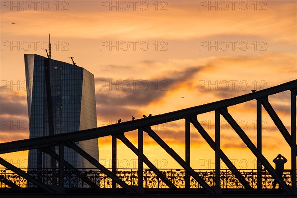 The sun rises behind the European Central Bank