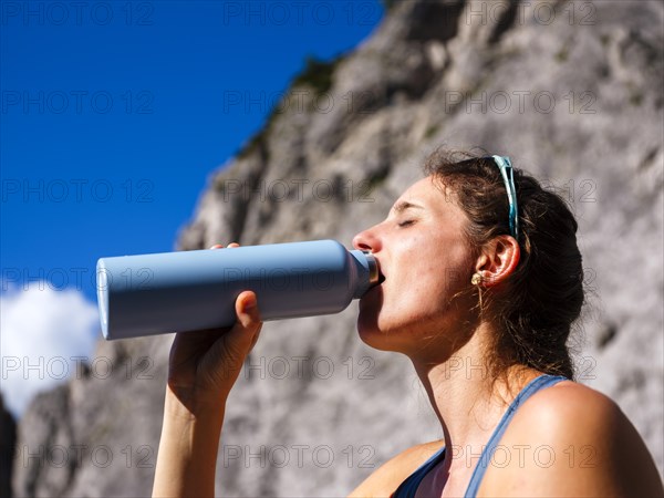 Young woman drinking from an outdoor bottle