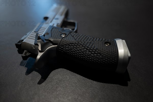 Elegant Chrome Handgun on Gray Granite Background in Switzerland