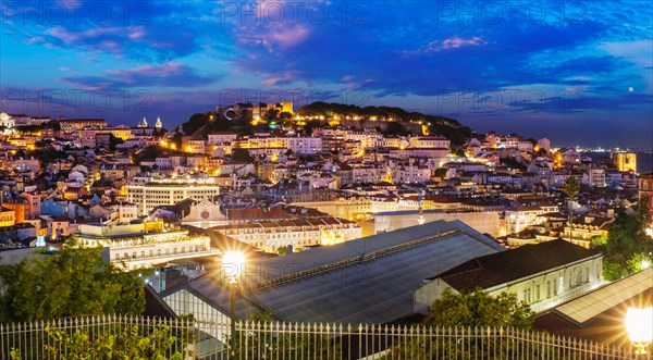 View of Lisbon famous view from Miradouro de Sao Pedro de Alcantara tourist viewpoint in the evening. Lisbon