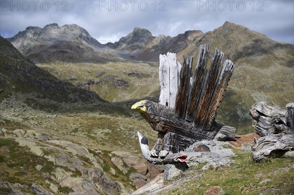 Wooden sculpture in the shape of a golden eagle with fish