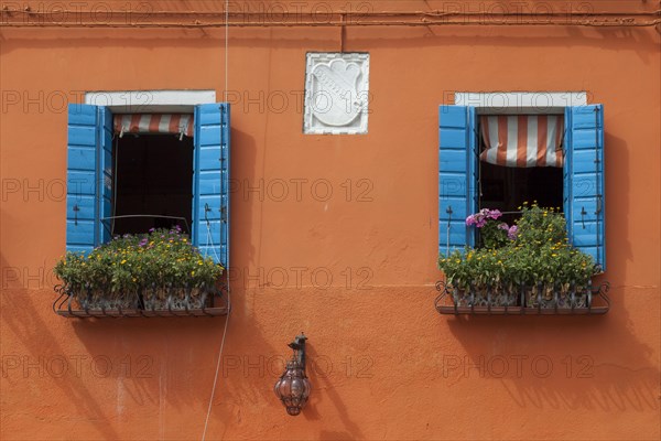 Orange house facade with two windows