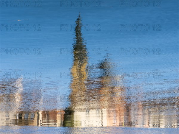 Town church reflected in the river Main