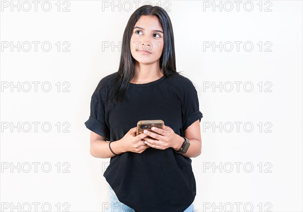 Thoughtful attractive girl holding phone isolated. Pensive latin girl holding smart phone on white background