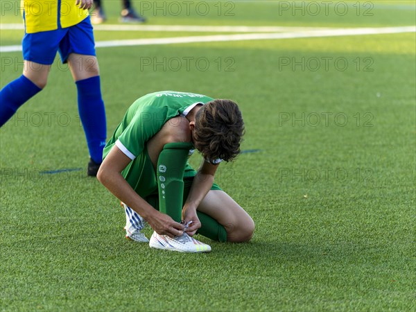 Young football player running across the pitch