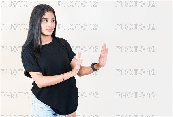 Displeased girl rejecting with palms hands isolated. Intense displeased young girl with rejection gesture. He frowns in disgust