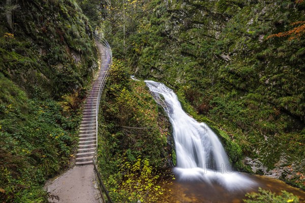 Mountain stream with waterfalls in autumn