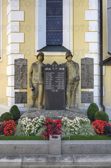War memorial with floral decorations in Wolfertschwenden