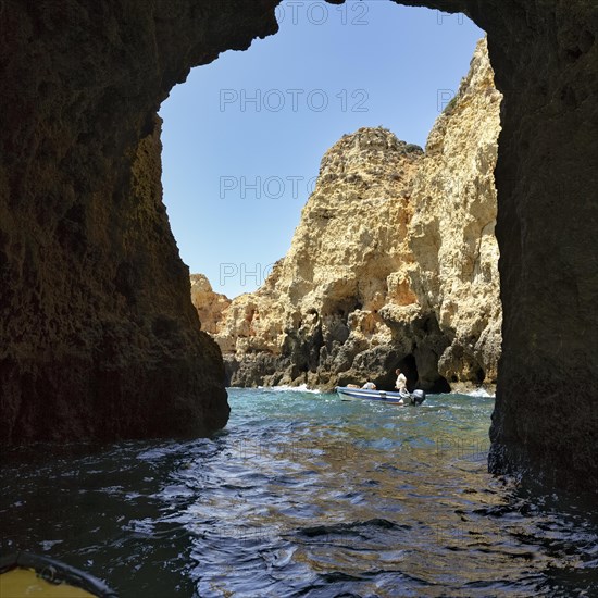 Tourists on a boat tour through the caves