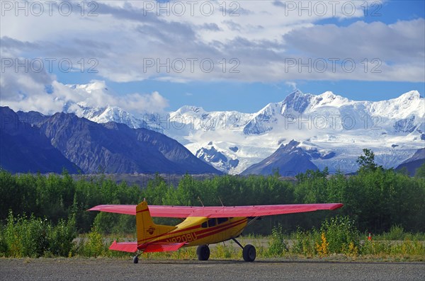 Small bush plane in front of huge glaciers