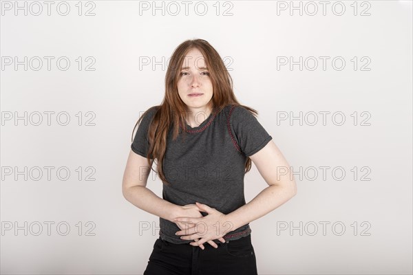 Young redhead woman with tummy pain