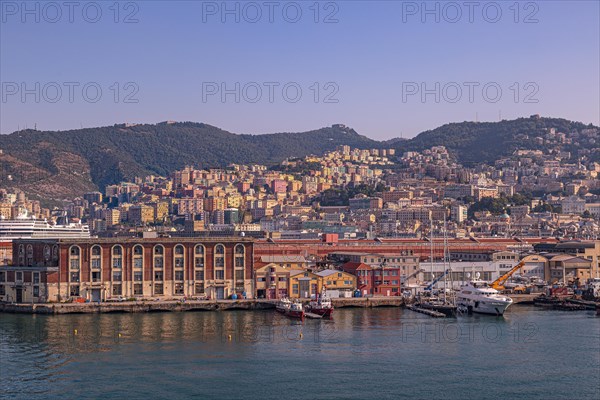 Port entrance of Genoa with its colourful houses and ships in the foreground Genoa Italy Europe