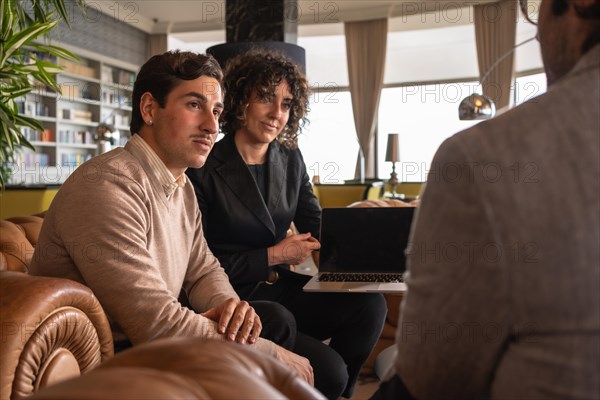 Focus on two business people listening carefully during a meeting in a hotel