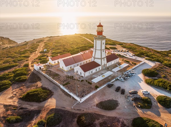 Aerial drone view of lighthouse on Cabo Espichel cape Espichel on Atlantic ocean at sunset. Sesimbra