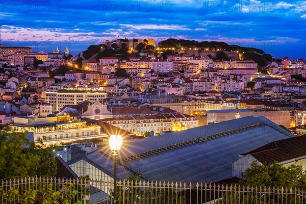 View of Lisbon famous view from Miradouro de Sao Pedro de Alcantara tourist viewpoint in the evening. Lisbon