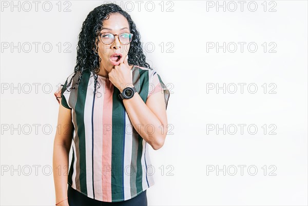 Amazed people with hand on chin looking at blank space. Amazed latin woman with hand on chin looking at copy space. Surprised girl looking at a promo