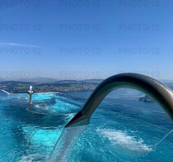 Infinity Swimming SPA Pool with View over Mountain and Lake Lucerne in a Sunny Day in Buergenstock