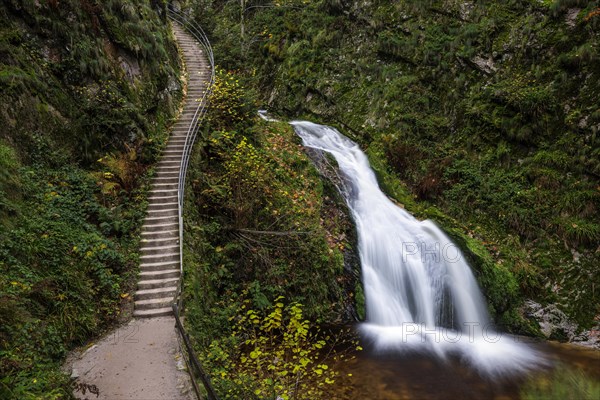 Mountain stream with waterfalls in autumn