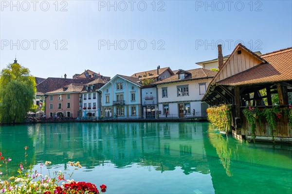 River Aare in City of Thun and Untere Schleuse Wooden Bridge in a Sunny Summer Day in Thun