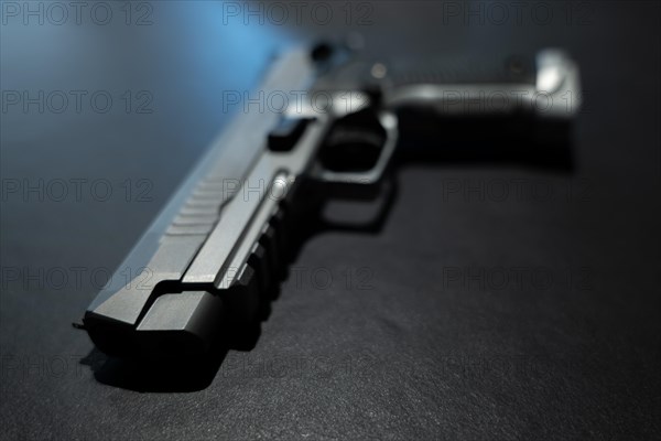Elegant Chrome Handgun on Gray Granite Background in Switzerland