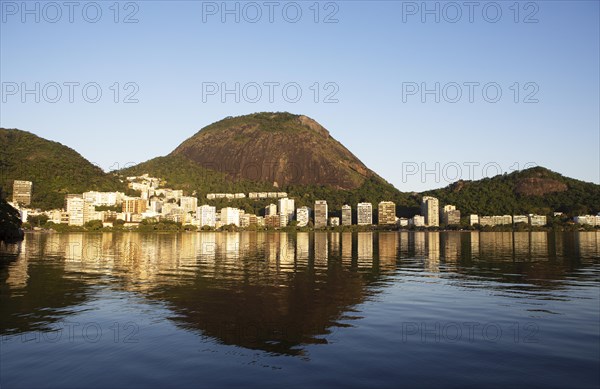 Houses and mountains reflected in the evening light in the lagoon Lagoa Rodrigo de Freitas