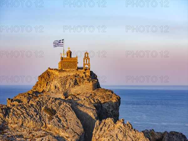 Chapel of St. Paisios perched on rocks at sunrise