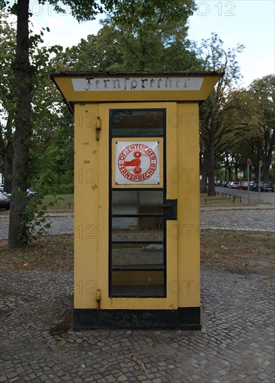 Old public telephone converted into a book box in Luebars