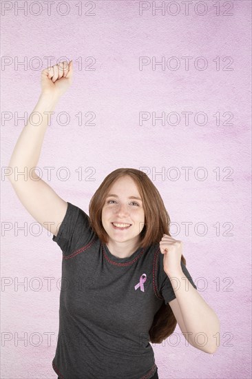 Woman wearing a pink breast cancer awareness ribbon. Concept of struggle with breast cancer