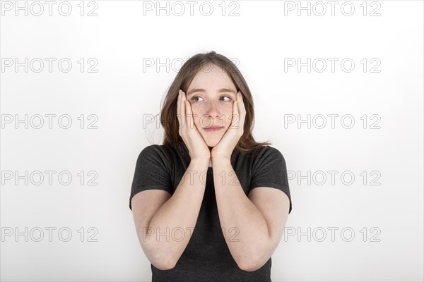 Red haired woman clutching her face