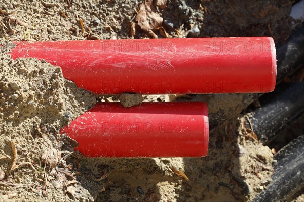 Red pipes in the sand on a construction site