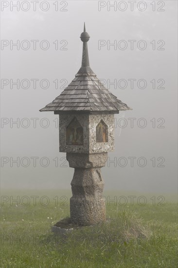 Wayside shrine in the autumnal fog