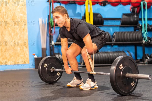 Handicapped man with an arm amputated weight lifting in a gym