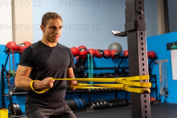 Portrait of a strong disabled man using an elastic band to work out