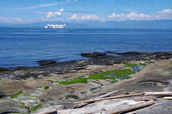 Beach and rocky bay with ferry