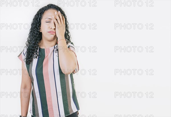 Stressed young woman holding her forehead. Stressed people with palm on forehead isolated. Worried young woman holding his forehead