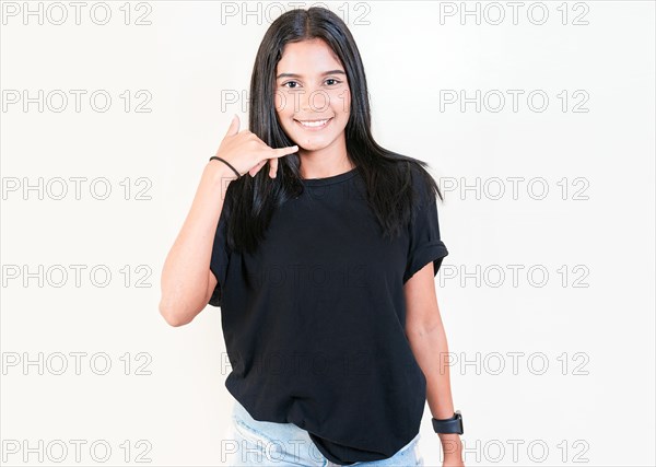 Happy latin girl gesturing call with fingers isolated. Smiling young girl gesturing call me with hand isolated