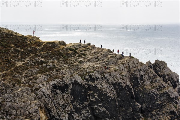 Hikers on rocky cliff